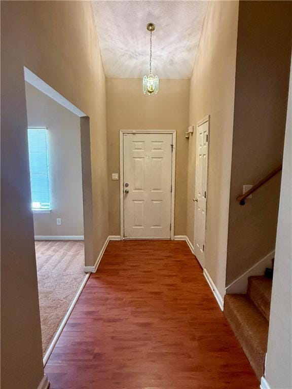 interior space with a chandelier, a high ceiling, and hardwood / wood-style floors