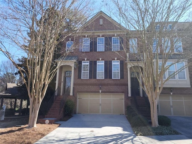 view of front of house featuring a garage, concrete driveway, and brick siding