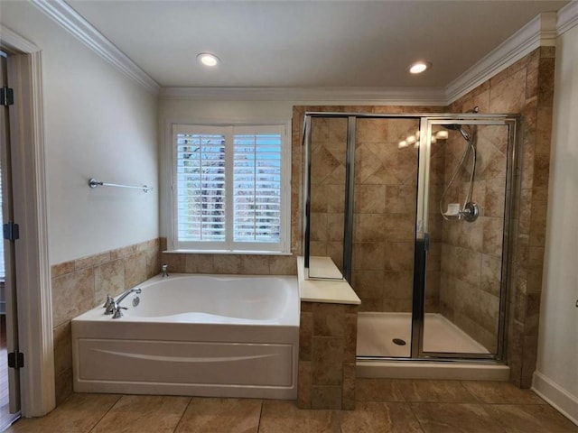 bathroom featuring a shower stall, crown molding, tile walls, and a bath