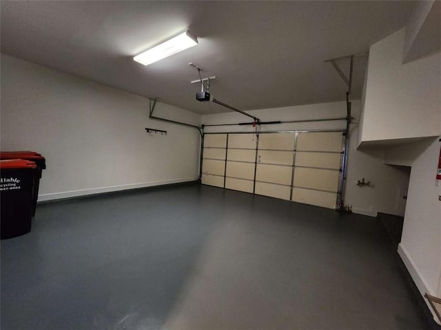 garage featuring baseboards and a garage door opener