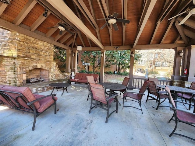 view of patio / terrace featuring a ceiling fan, outdoor dining area, a gazebo, and an outdoor living space with a fireplace