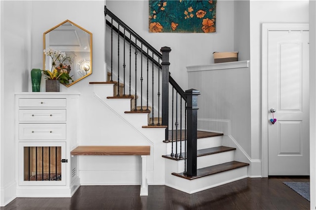 staircase featuring wood finished floors