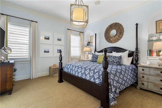 carpeted bedroom with ornamental molding and baseboards