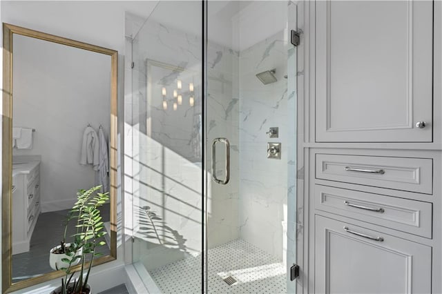 bathroom featuring a marble finish shower