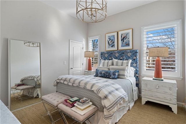 carpeted bedroom featuring a closet and an inviting chandelier