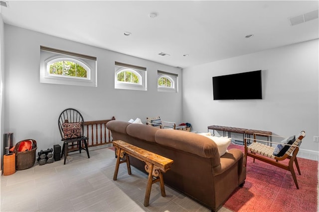 living area featuring plenty of natural light, visible vents, and recessed lighting