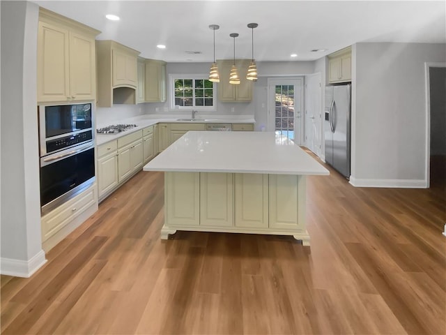 1950 S Inlet, Marietta, GA 30066 - kitchen featuring light countertops, appliances with stainless steel finishes, baseboards, and a kitchen island