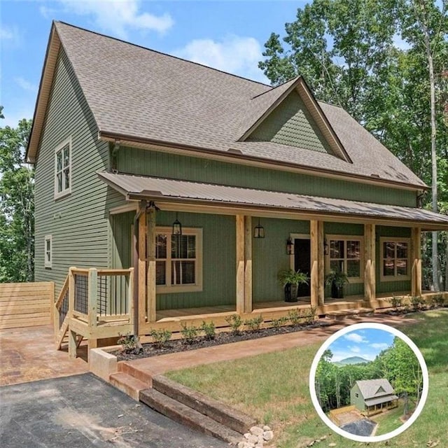 rear view of property with covered porch