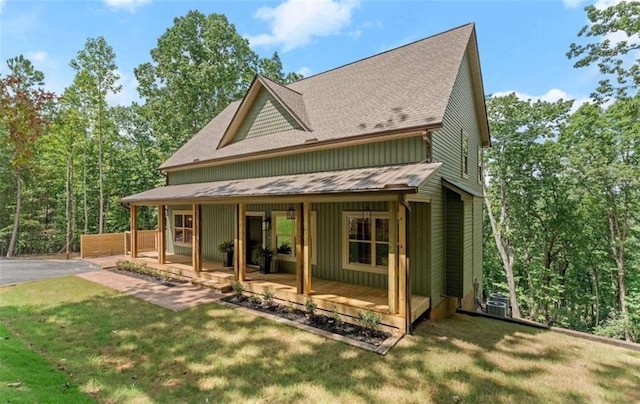 back of property featuring central AC, a yard, and a porch