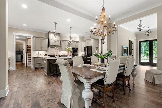 131 Forsyth Park Ln, Woodstock, GA 30188 - dining room with crown molding, a chandelier, dark wood-type flooring, recessed lighting, and french doors