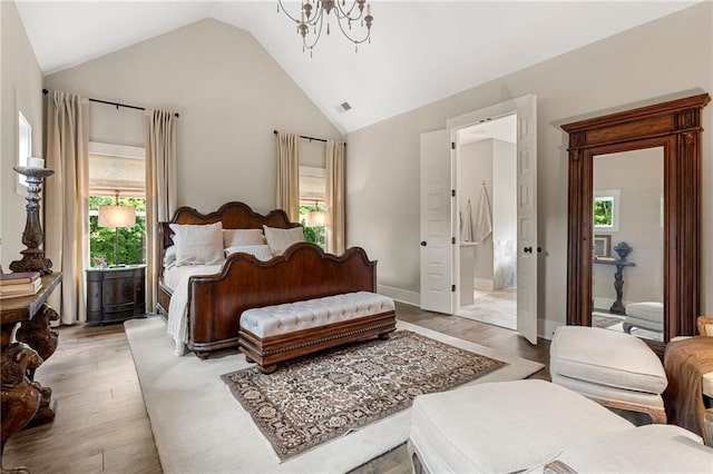 131 Forsyth Park Ln, Woodstock, GA 30188 - bedroom with light wood finished floors, multiple windows, a chandelier, and high vaulted ceiling