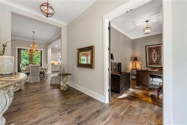 131 Forsyth Park Ln, Woodstock, GA 30188 - foyer featuring a chandelier, dark wood-style floors, crown molding, and baseboards