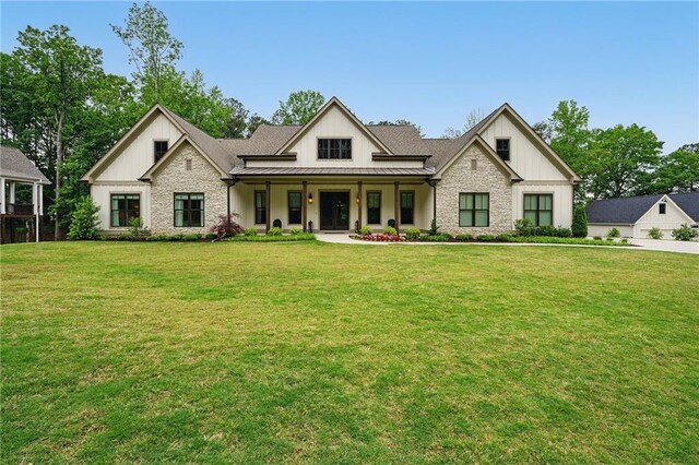 131 Forsyth Park Ln, Woodstock, GA 30188 - modern farmhouse style home with a standing seam roof, board and batten siding, stone siding, a porch, and a front lawn