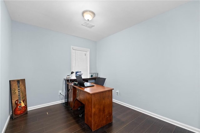 home office with dark wood-style floors and baseboards