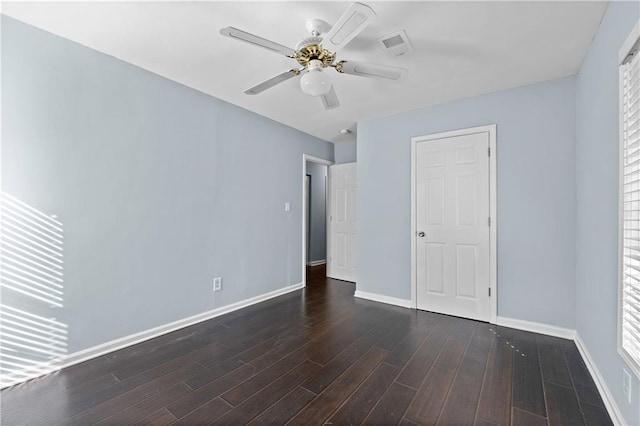 unfurnished bedroom with visible vents, baseboards, ceiling fan, and wood finished floors