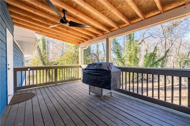 wooden terrace featuring a ceiling fan and area for grilling