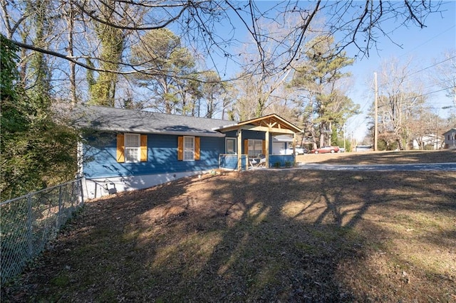 view of front of home featuring fence