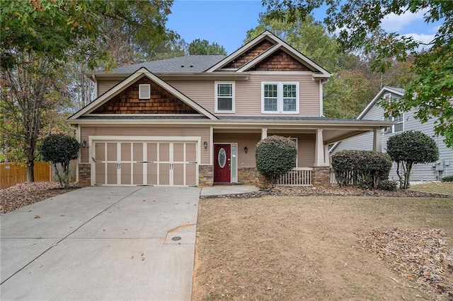 craftsman-style home featuring covered porch and a garage