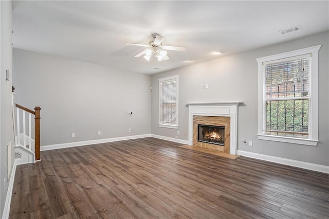 unfurnished living room with ceiling fan and dark hardwood / wood-style flooring