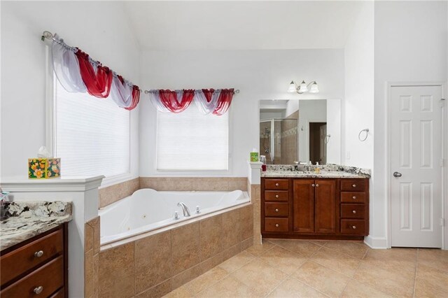 full bathroom featuring tile patterned flooring, a shower stall, vanity, and a bath