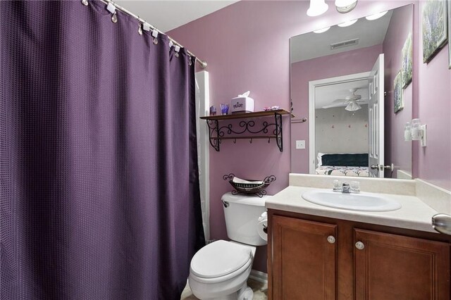 ensuite bathroom featuring visible vents, connected bathroom, vanity, and toilet