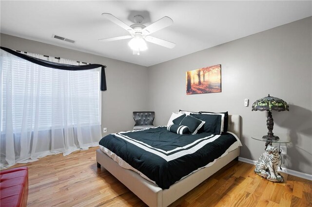 bedroom with light wood-type flooring, multiple windows, and visible vents