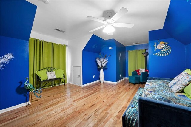 bedroom featuring ceiling fan, wood finished floors, visible vents, and baseboards