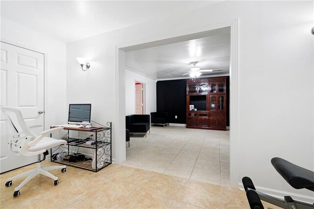 office area with a ceiling fan, light tile patterned flooring, and baseboards