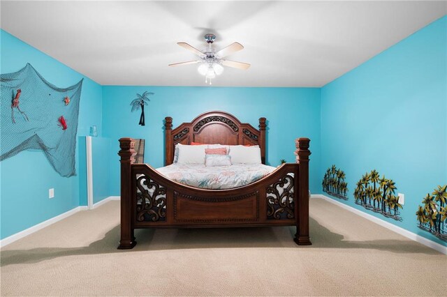 bedroom with a ceiling fan, light colored carpet, and baseboards