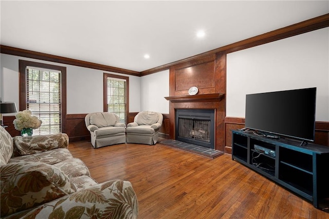 4140 Westchester Xing NE, Roswell, GA 30075 - living room featuring wainscoting, wood finished floors, ornamental molding, and a tile fireplace