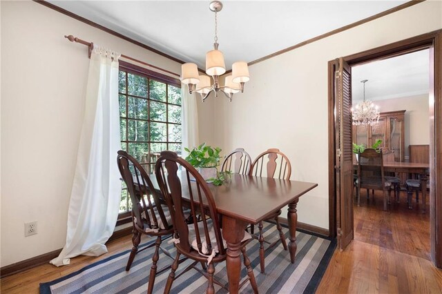 4140 Westchester Xing NE, Roswell, GA 30075 - dining room featuring crown molding, baseboards, a chandelier, and wood finished floors