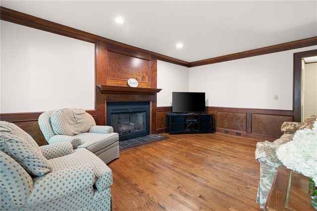 4140 Westchester Xing NE, Roswell, GA 30075 - living area featuring recessed lighting, a fireplace, crown molding, a wainscoted wall, and wood finished floors