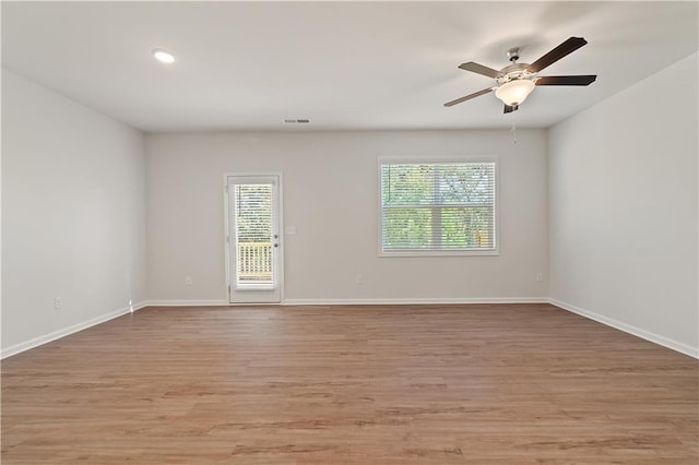 spare room featuring light wood-type flooring and ceiling fan