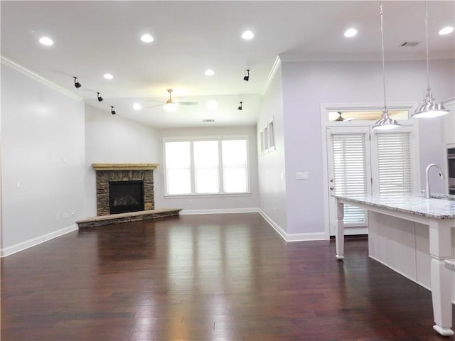 330 La Perla Dr, Sugar Hill, GA 30518 - unfurnished living room featuring a ceiling fan, crown molding, dark wood-style flooring, a fireplace, and recessed lighting