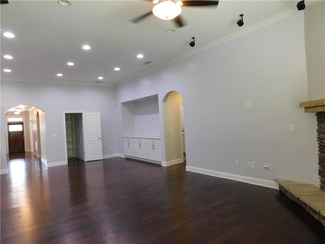 330 La Perla Dr, Sugar Hill, GA 30518 - unfurnished living room with arched walkways, a ceiling fan, ornamental molding, recessed lighting, and dark wood-style flooring