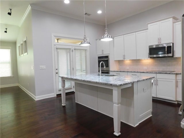 330 La Perla Dr, Sugar Hill, GA 30518 - kitchen with stainless steel appliances, backsplash, crown molding, a kitchen island with sink, and white cabinets
