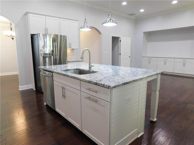 330 La Perla Dr, Sugar Hill, GA 30518 - kitchen featuring arched walkways, stainless steel appliances, white cabinets, light stone countertops, and ornamental molding