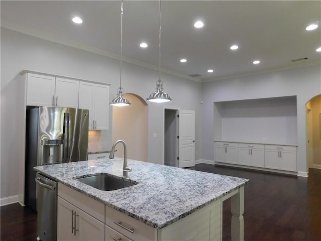 330 La Perla Dr, Sugar Hill, GA 30518 - kitchen featuring arched walkways, ornamental molding, a kitchen island with sink, light stone counters, and dark wood-style flooring