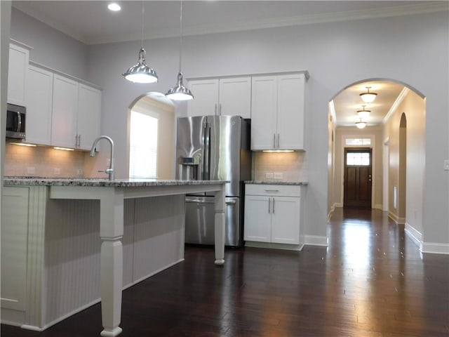330 La Perla Dr, Sugar Hill, GA 30518 - kitchen with stainless steel appliances, ornamental molding, backsplash, white cabinets, and light stone countertops