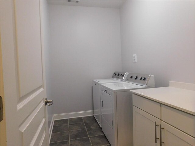 330 La Perla Dr, Sugar Hill, GA 30518 - laundry room featuring separate washer and dryer, cabinet space, and dark tile patterned flooring
