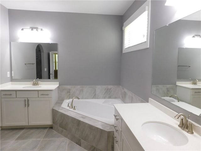 330 La Perla Dr, Sugar Hill, GA 30518 - bathroom with a garden tub, two vanities, and marble look tiles