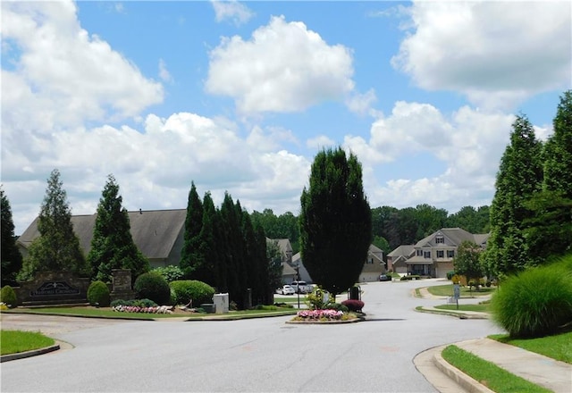 330 La Perla Dr, Sugar Hill, GA 30518 - view of asphalt road featuring curbs, sidewalks, and a residential view