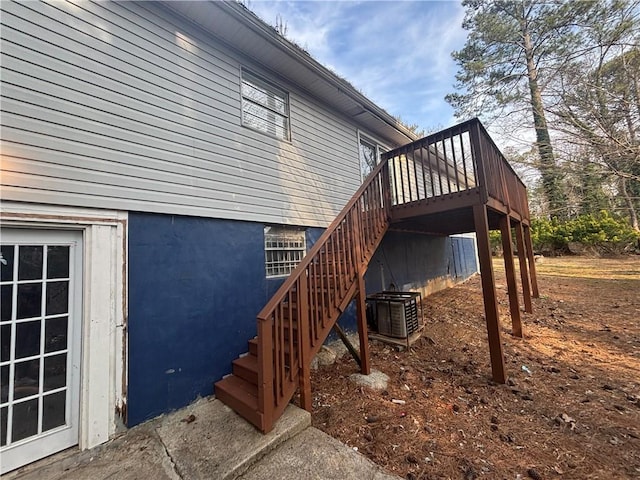 view of home's exterior with a wooden deck and central air condition unit