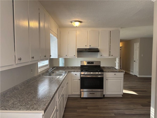 kitchen with sink, dark wood-type flooring, a textured ceiling, white cabinets, and stainless steel range with gas cooktop