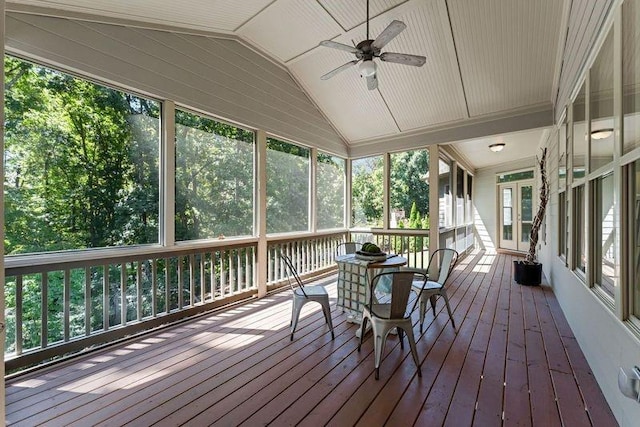 unfurnished sunroom with ceiling fan and lofted ceiling