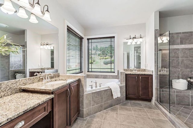 bathroom with tile patterned flooring, vanity, and independent shower and bath