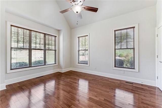 empty room featuring dark hardwood / wood-style floors, ceiling fan, and lofted ceiling