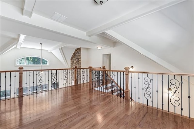 additional living space with lofted ceiling with beams and hardwood / wood-style flooring