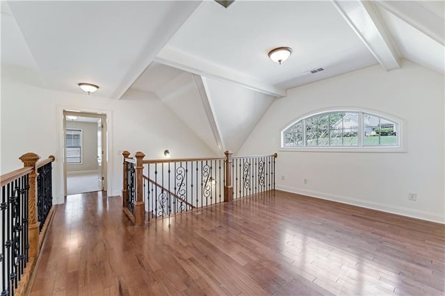 interior space featuring vaulted ceiling with beams and dark hardwood / wood-style floors