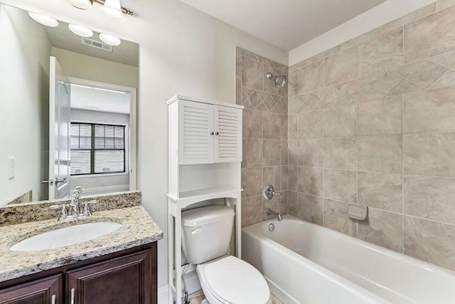 full bathroom with vanity, toilet, and tiled shower / bath